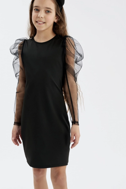 Girl in the black Elena dress with tulle sleeves, front view